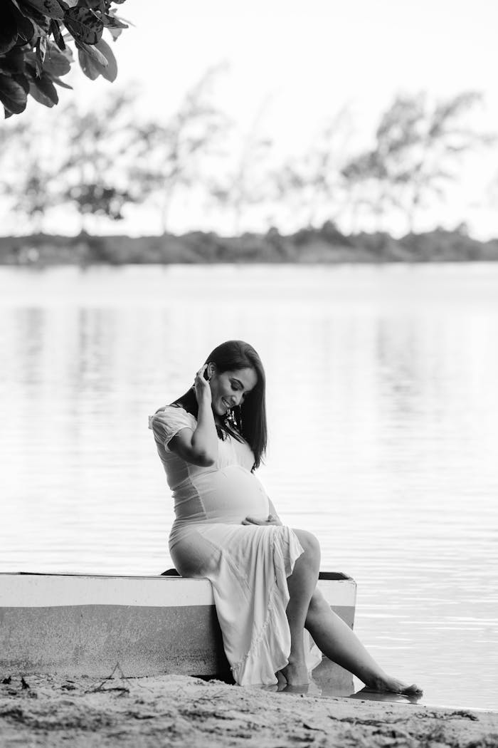 Monochrome Photo of Woman in White Dress Smiling